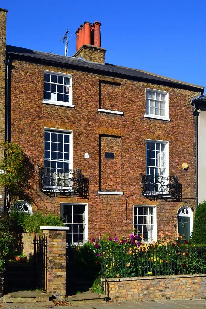 Brick period houses on Downshire Hill in Hampstead with sash windows and a front garden wall
