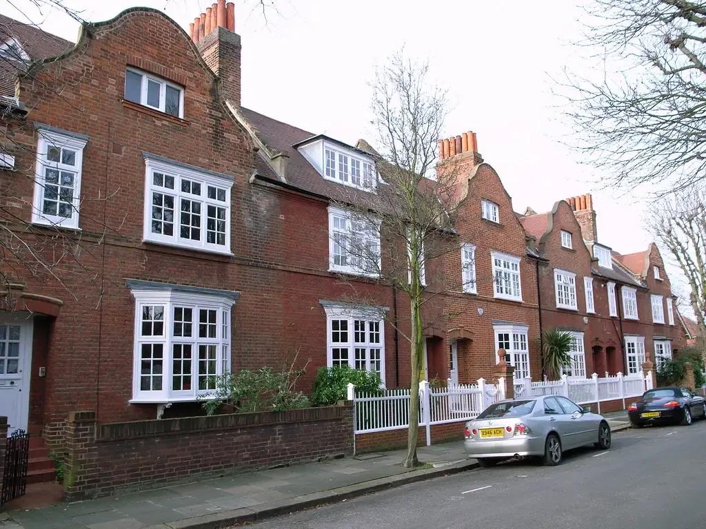 Red-brick Queen Anne style houses on Marlborough Crescent in Bedford Park with white sash windows