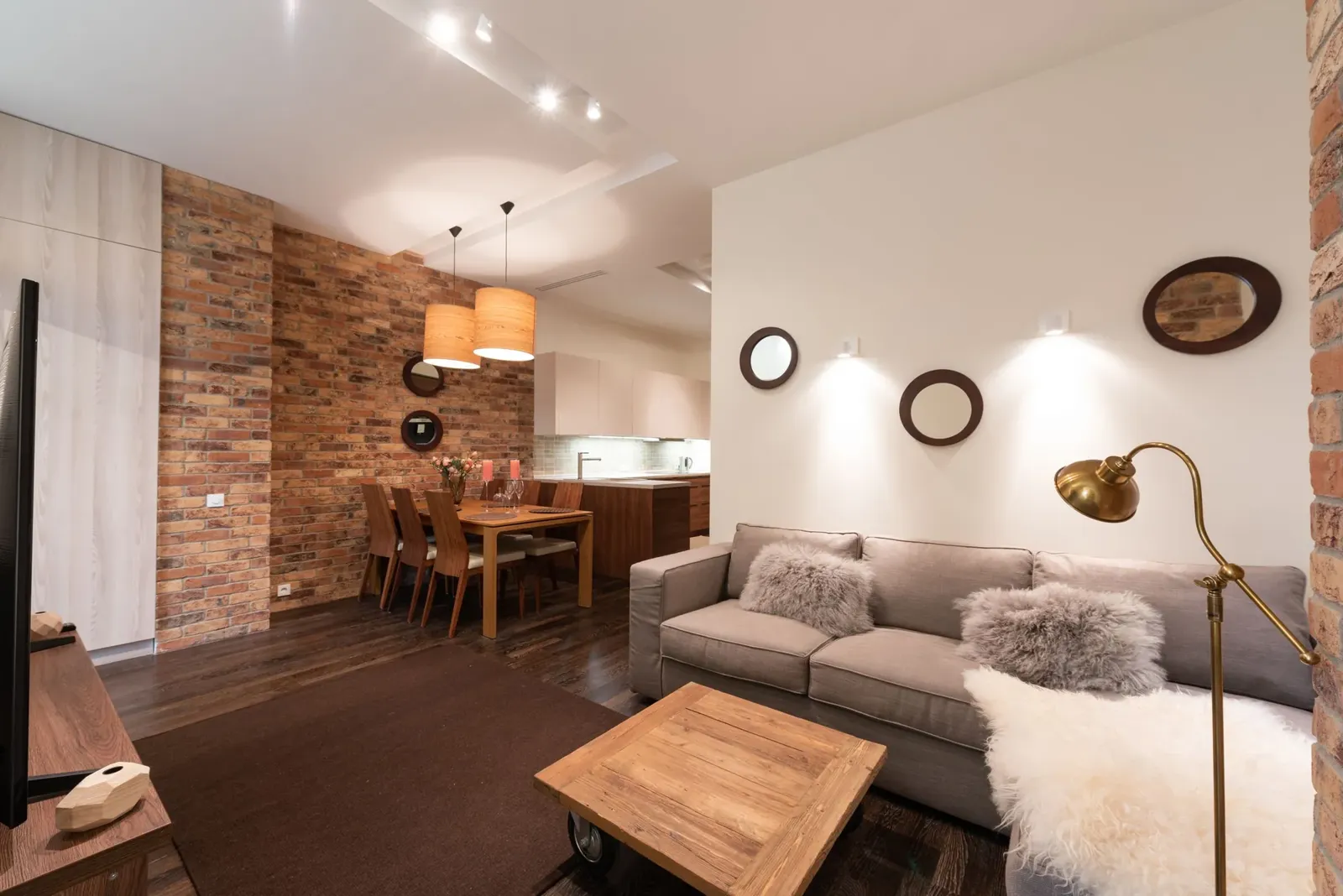 Bright modern extension interior with a large glazed wall, dining table and seating facing the garden