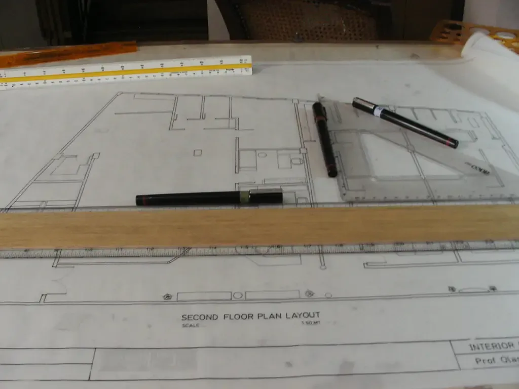 Second-floor plan laid out on a drawing board with a parallel rule, pens and a scale