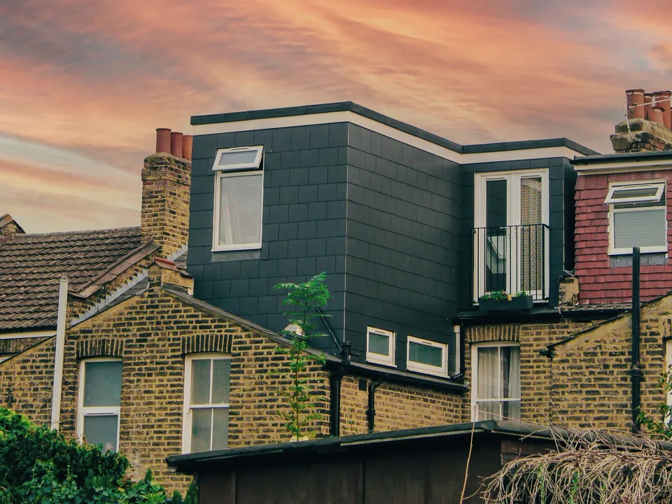 Slate-clad roof extension on a yellow-brick London terraced house