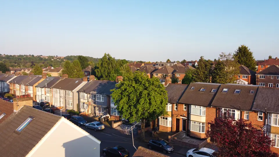 Rows of brick terraced houses and gardens on a residential street